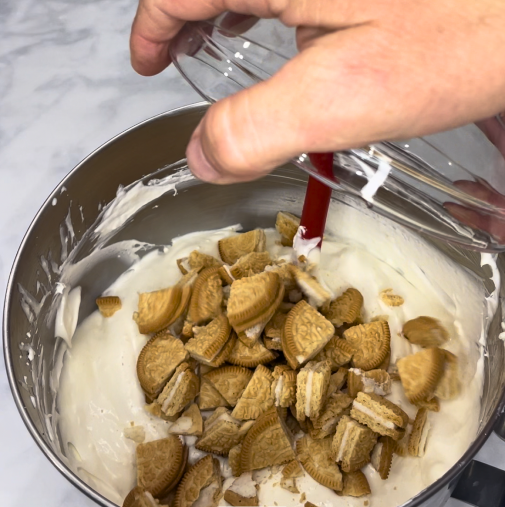 adding chopped cookies to batter
