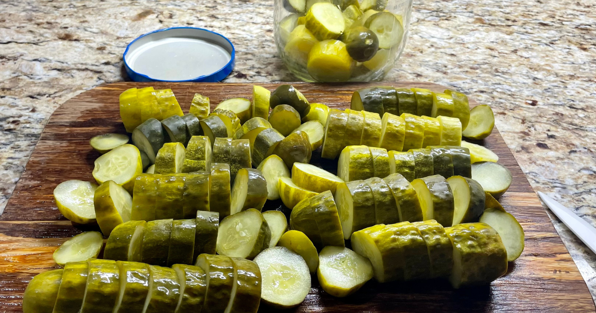 Pickles cut into chunks on a cutting board