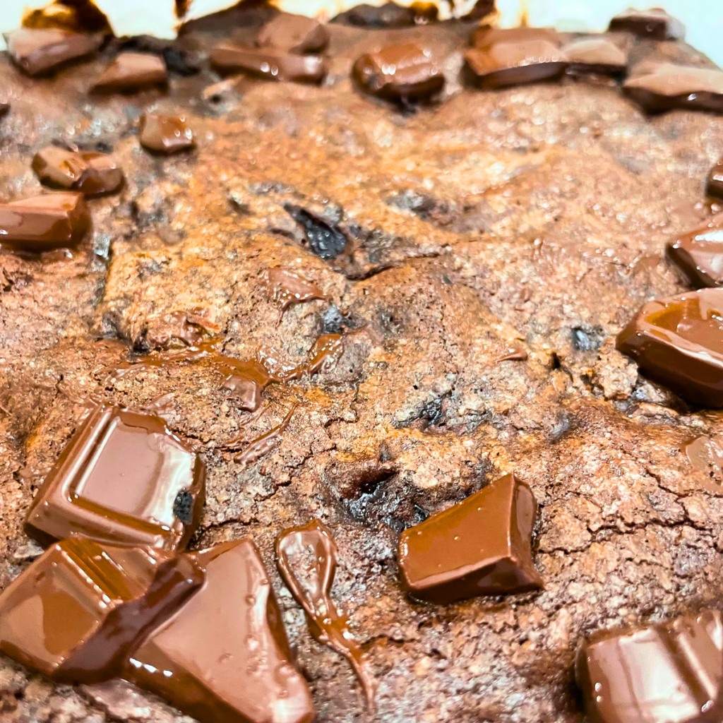image of the chocolate chunks melting on top of the baked brownies