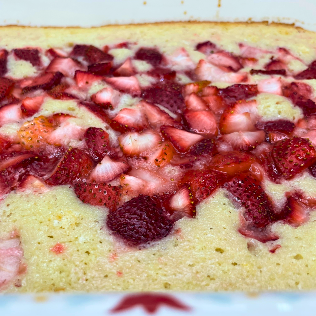 Close up of the completed cake showing the moist and airy yellow cake with the embedded chucks of fresh strawberries