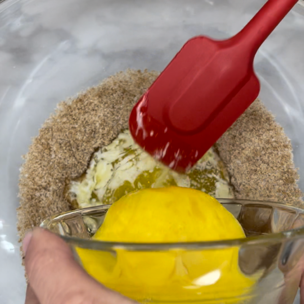 Adding in the eggs and butter to the graham cracker cookie batter