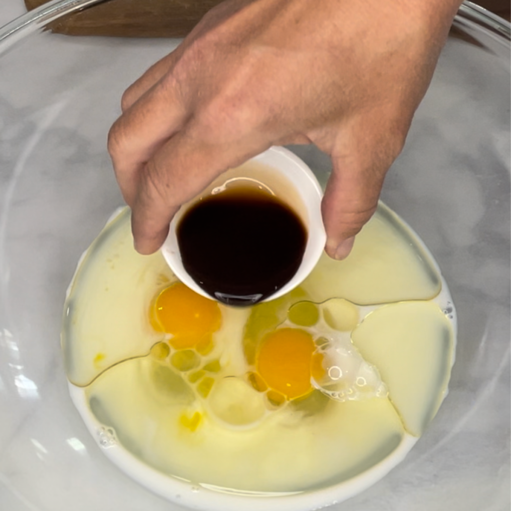 pouring vanilla into wet ingredients
